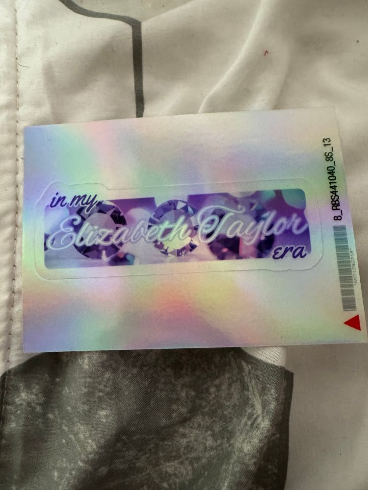 In my Elizabeth Taylor era stickers holographic print with the words over a picture of a violet background with diamonds