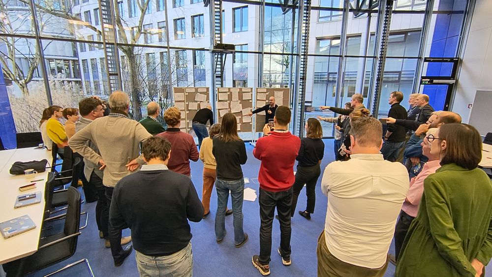 People standibng in front of screens in Open Space excercise and having ideas for the next sessions