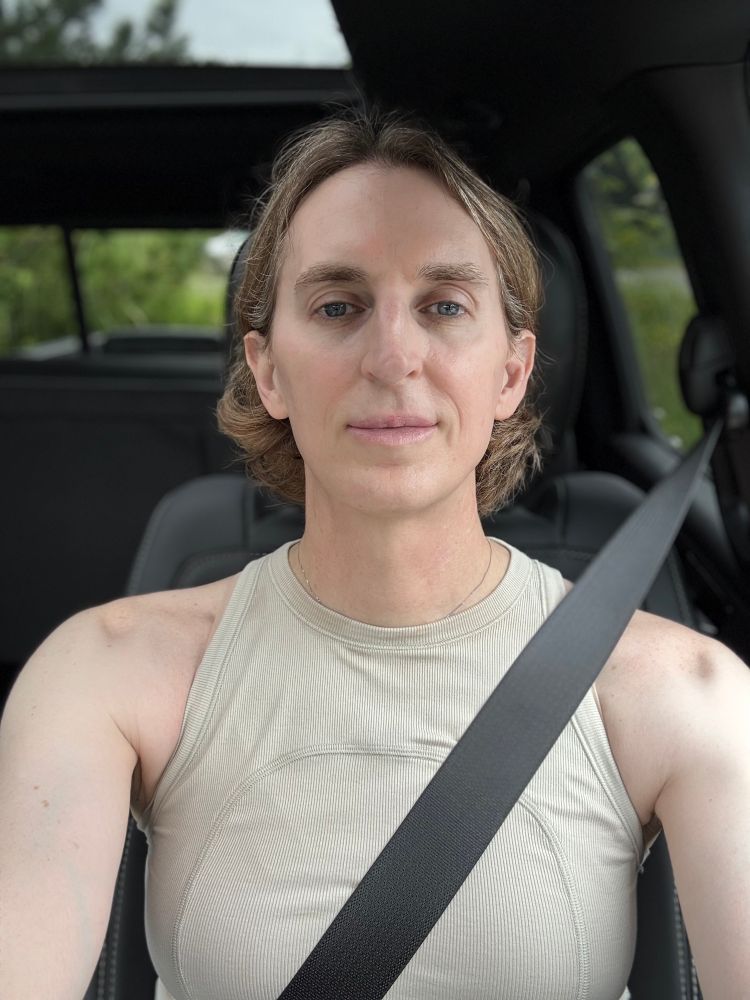 Image of a transgender woman after having exercised at the gym for an hour and half, looking like a bad ass bitch with a beige tank top, 34DD boobs, a cute slicked by hairstyle, in a butch Ram Rebel truck 💅 because she will cut a bitch 💋