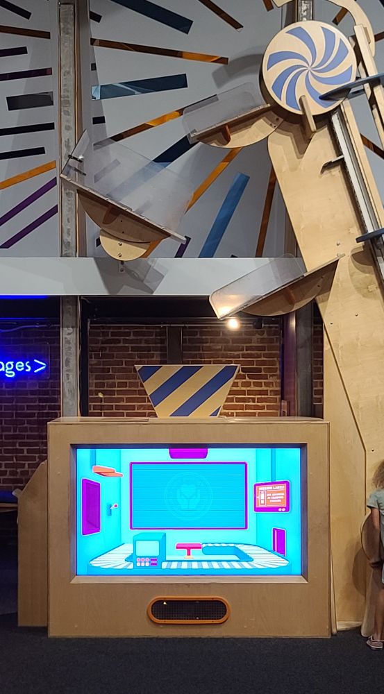 Package delivery exhibit with a lift and a screen that animates when packages are dropped into the machine