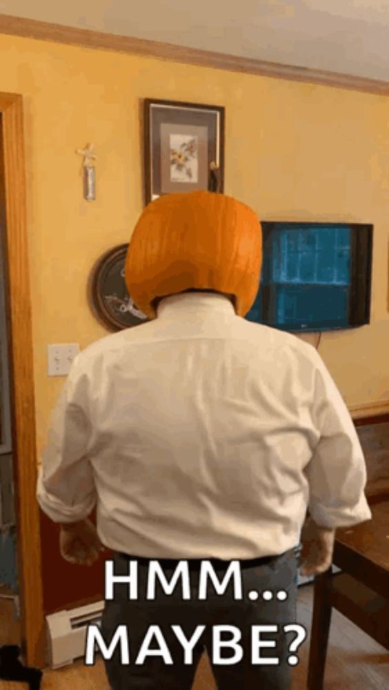 a man wearing a pumpkin on his head says " hmm ... maybe "