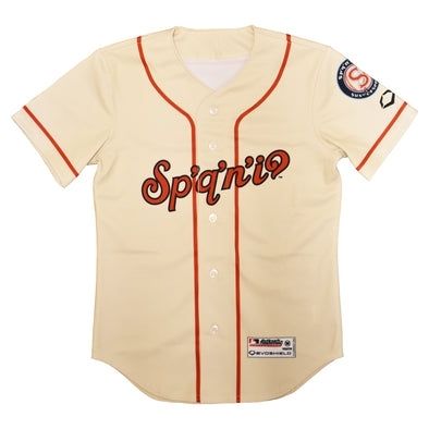 A white and red baseball jersey with text in Salish language
