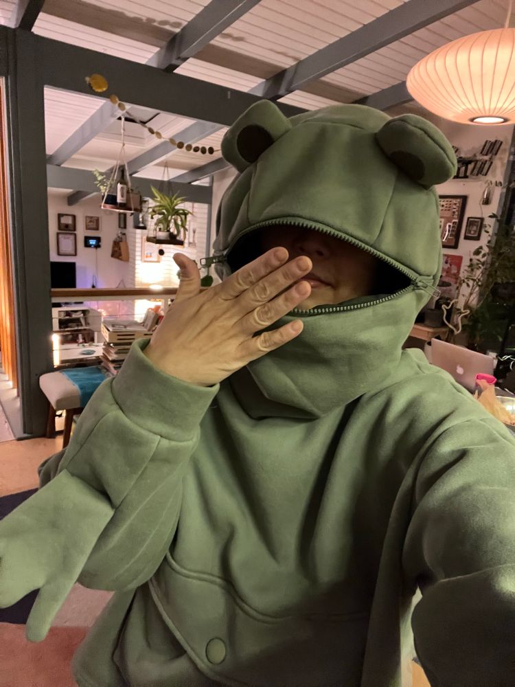 Frog hoodie with the mouth unzipped and my hand over the mouth 