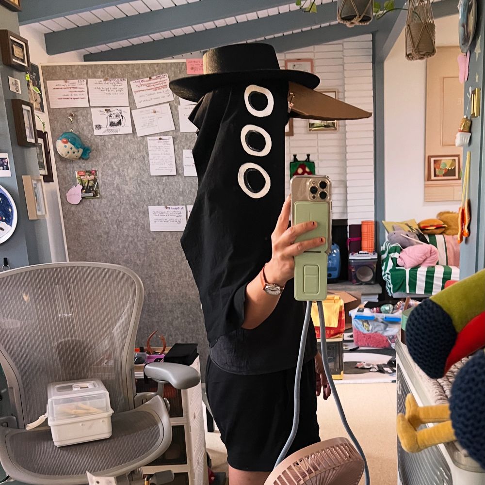 Me trying on a black bird head costume im making with three white eyes 