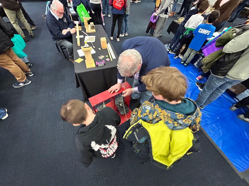 Image of the boys playing with pulleys at the simple machines booth.