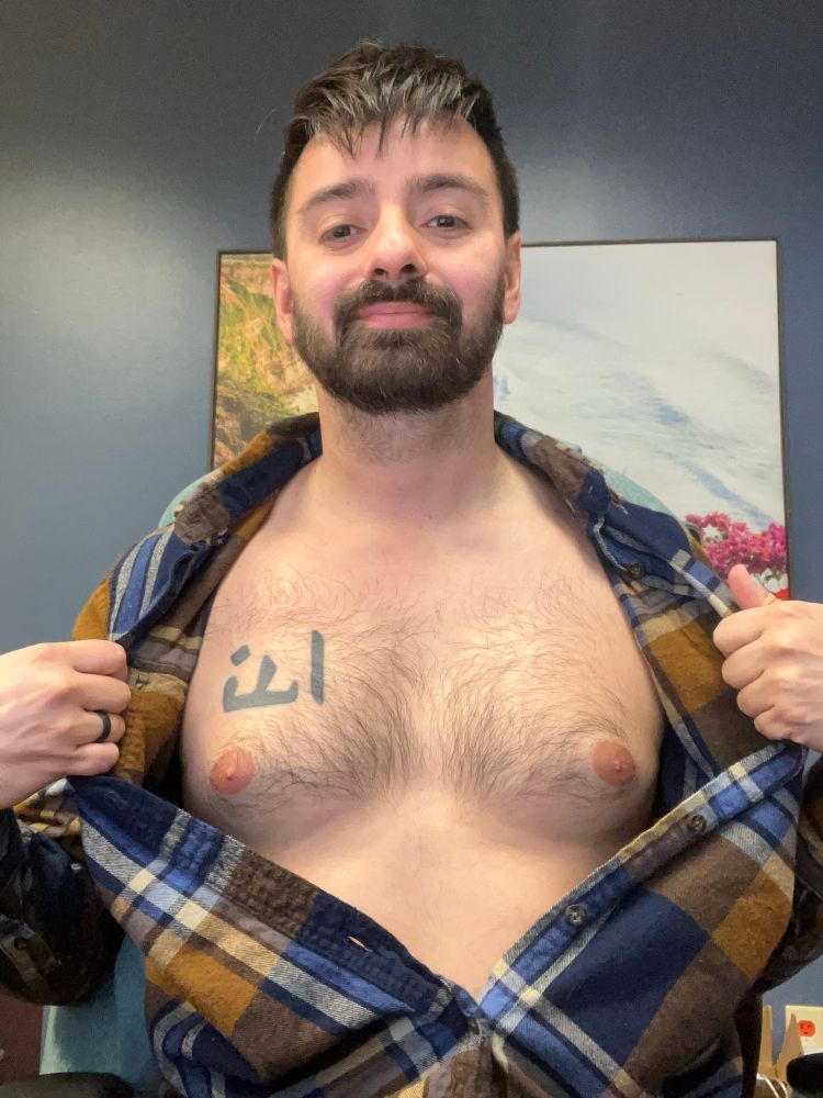 Me sitting at office chair with buttoned up plaid shirt open