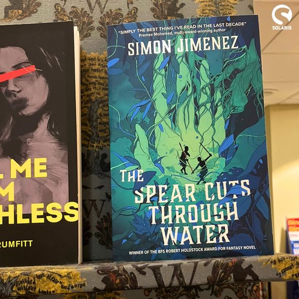 A paperback copy of THE SPEAR CUTS THROUGH WATER on display in Waterstones. The white Solaris logo is in the top right corner.