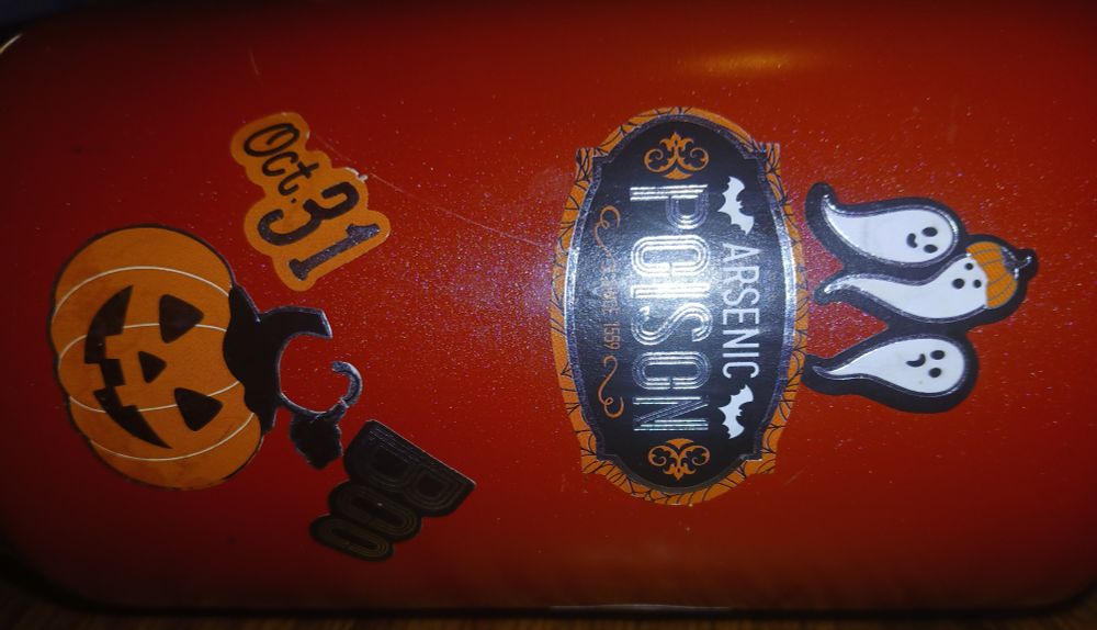 Big red metal cup (like a stanley)

5 stickers
3 Ghosts and one has a pumpkin hat
A sign with orange edges, black background, orange fancy swirls, 2 white bats, and white letters that read Arsenic in small letters and Poison in big letters. 
Orange and silver Oct. 31
A silver and black Boo
And a black, orange, and silver Jack-o'lantern 