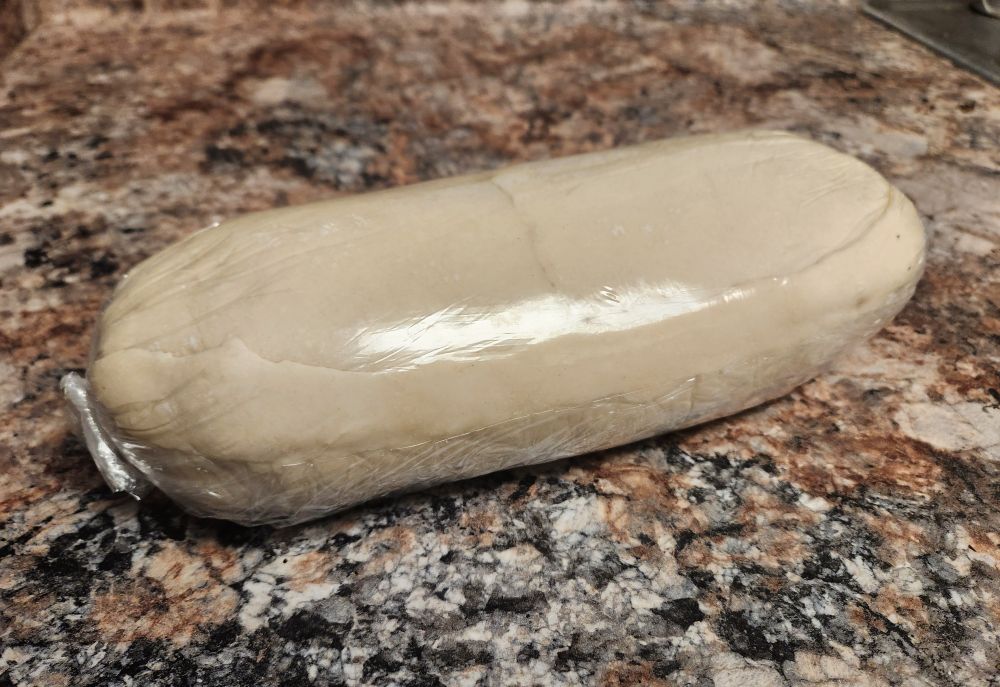 the same assembly, this time with raw puff pastry under the plastic wrap