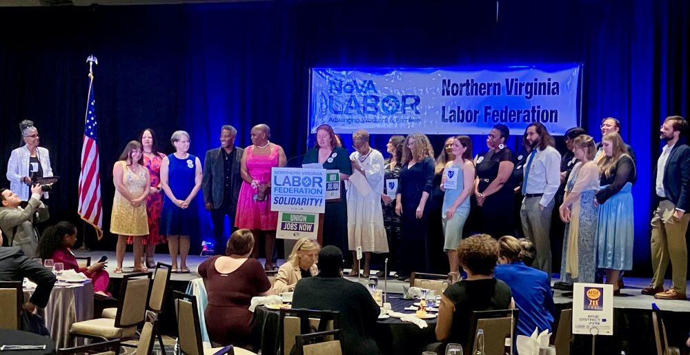 At the NoVA Labor Federation dinner, a large crowd is honored on stage.
