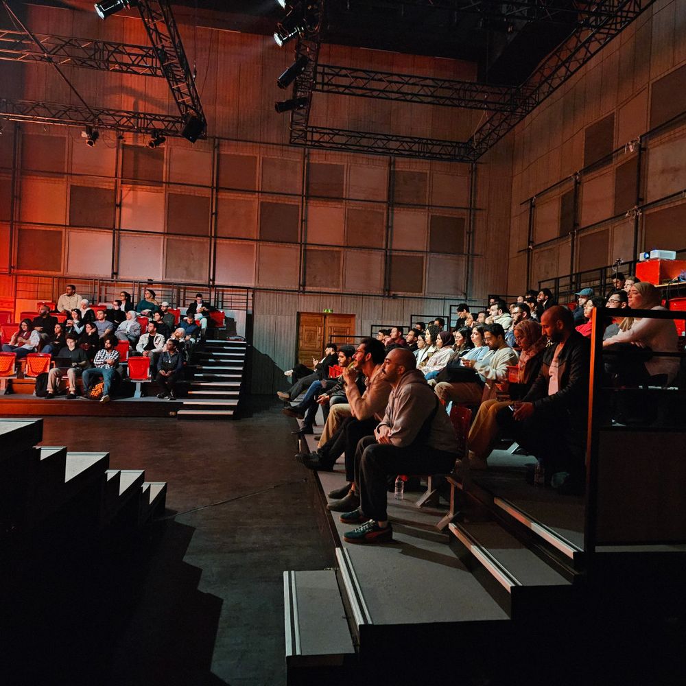 Attendees in the conference room focused on the talk
