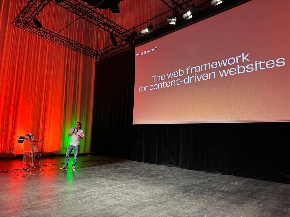 Speaker on stage in front of screen