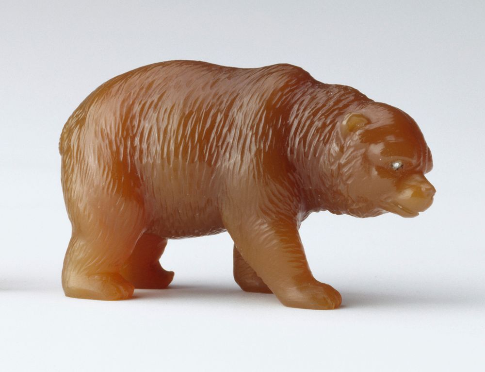 A brown bear, carved in agate with rose cut diamond eyes. Chiselled on one paw C and on the other F, the initials of Carl Fabergé.
(official photo of object, side profile on white background - Royal Collection Trust / © His Majesty King Charles III 2024)