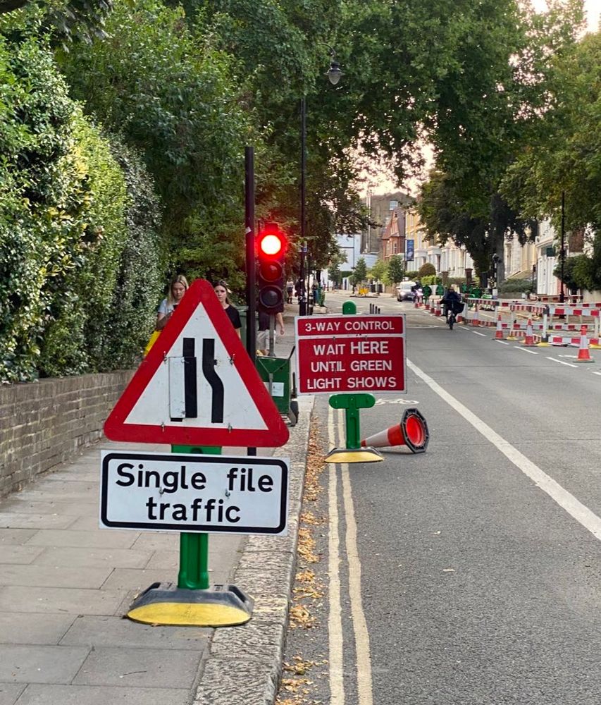 Two temporary road signs, but with a heavy plastic Base. They take up less footprint than normal metal tent style frames.