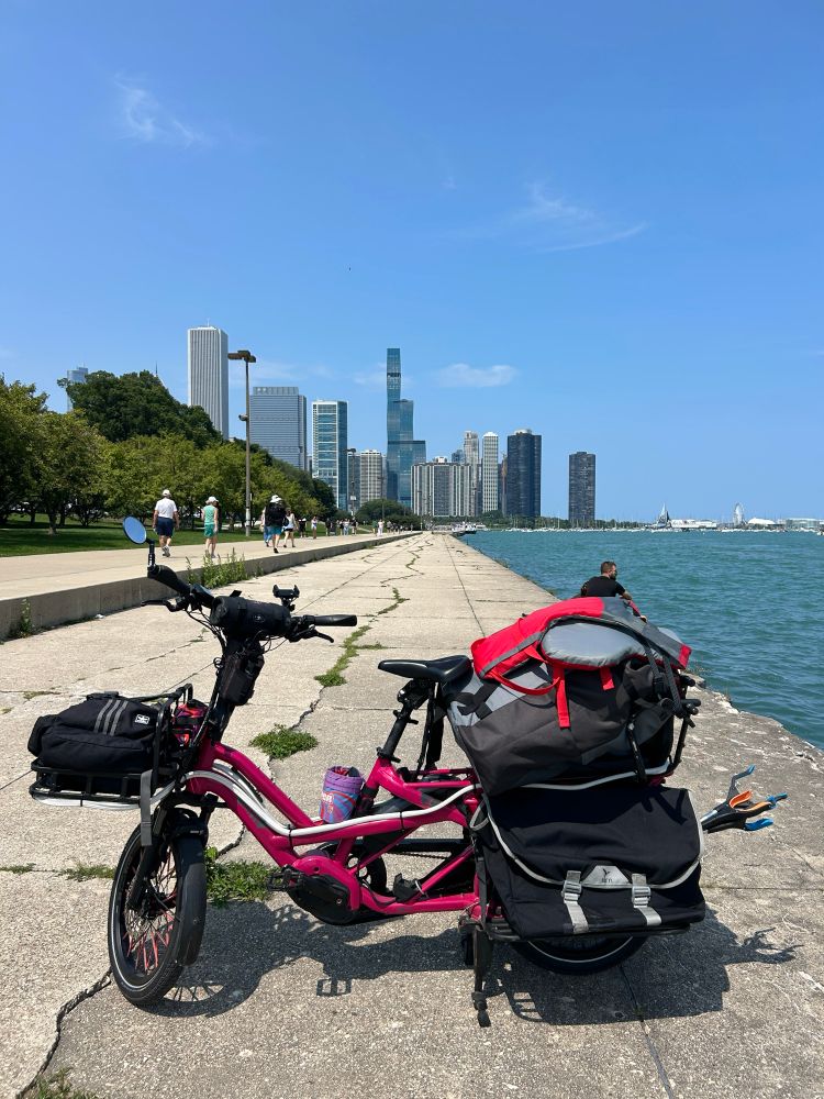Tern GSD cargo bike with kayak and gear next to Lake Michigan, Chicago skyline in the background 