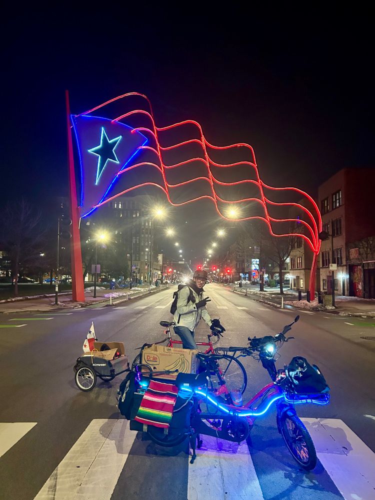 Posing in front of the Puerto Rican flag draped across the street next to Humboldt park 