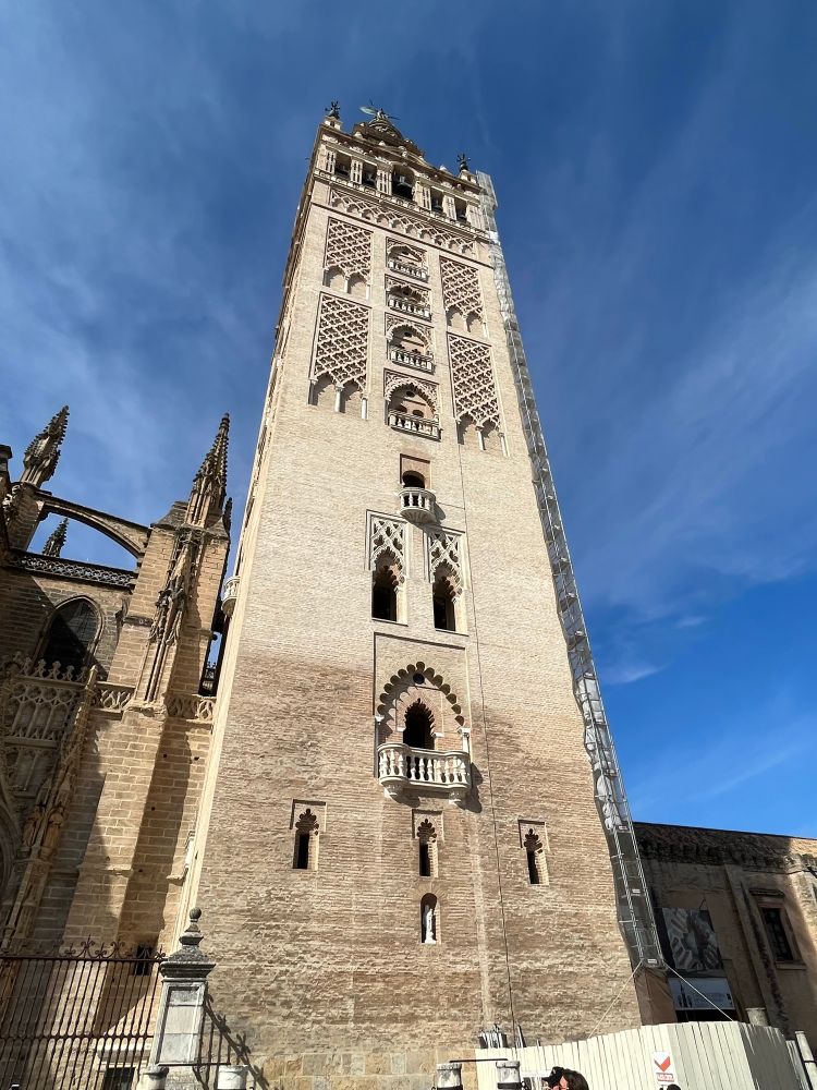 The Giralda in Seville, Spain. It was built as the minaret for the Great Mosque of Seville then converted to a bell tower for the cathedral. The photo shows the extensive height of the structure as well as traditional Spanish/Arabic design. Photo by Robert Emond. 