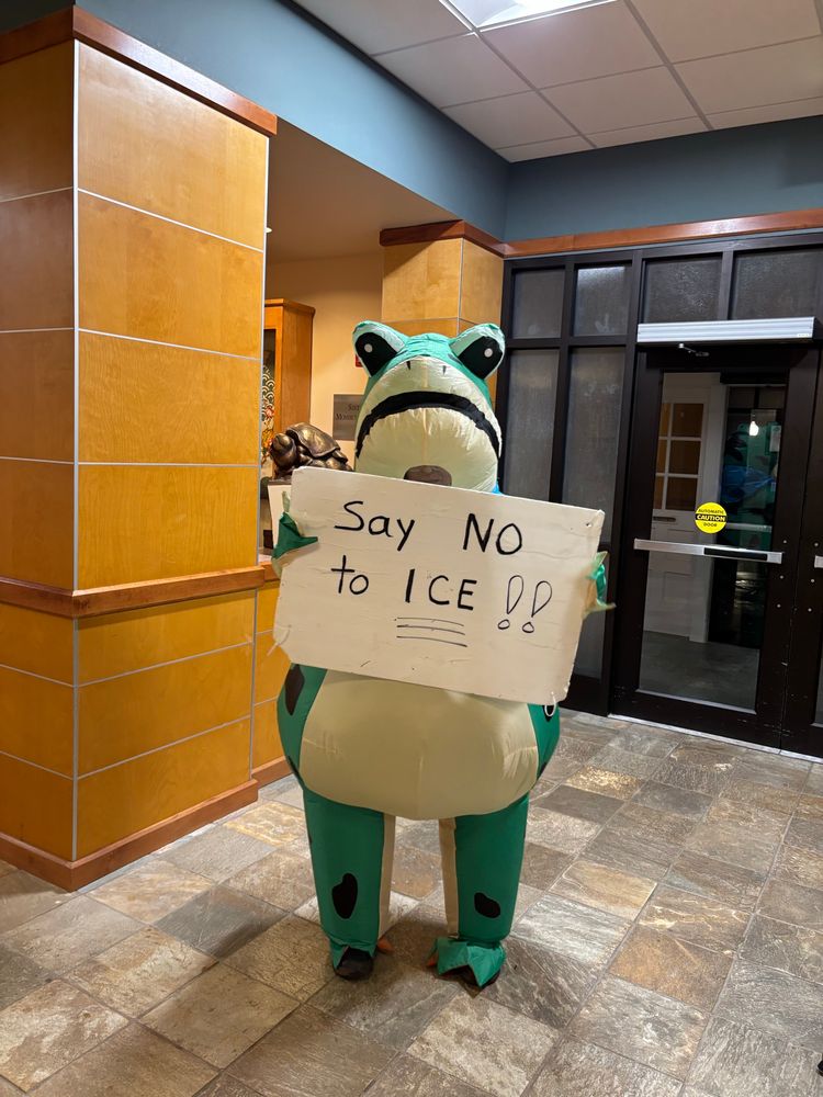 A protestor in a frog costume holding a sign “Say NO to ICE”. Photo by Robert Emond. 