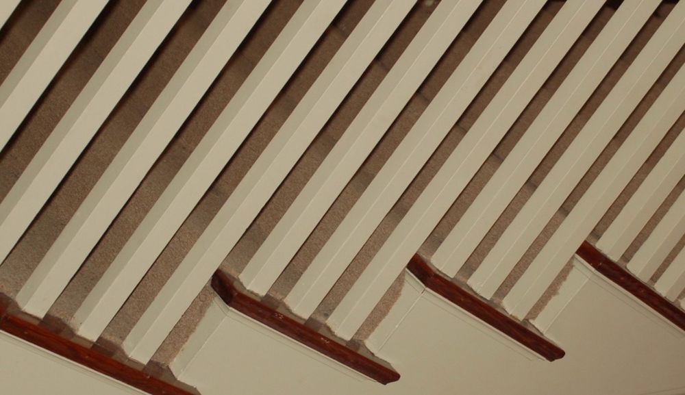 A stair baluster and treads photographed at a Dutch angle. Photo by Robert Emond. 