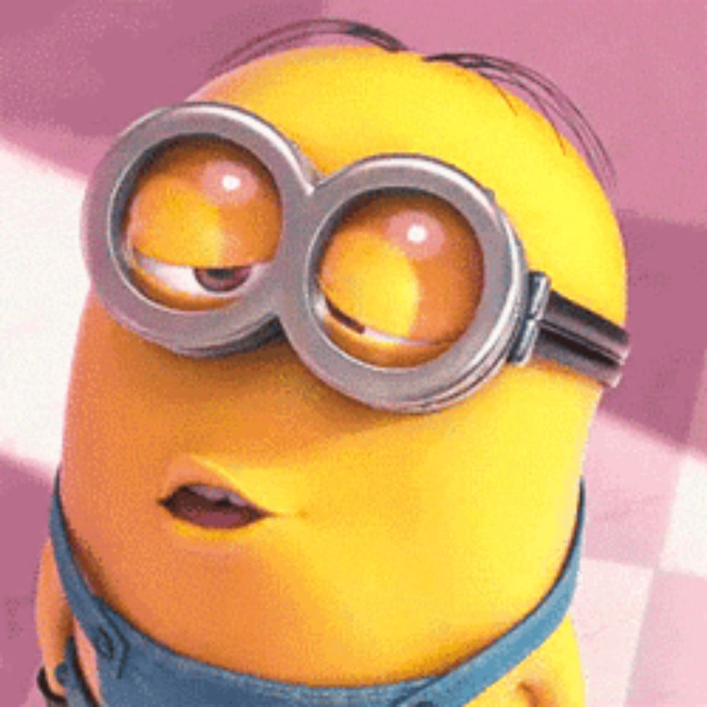 a close up of a minion wearing goggles and making a face