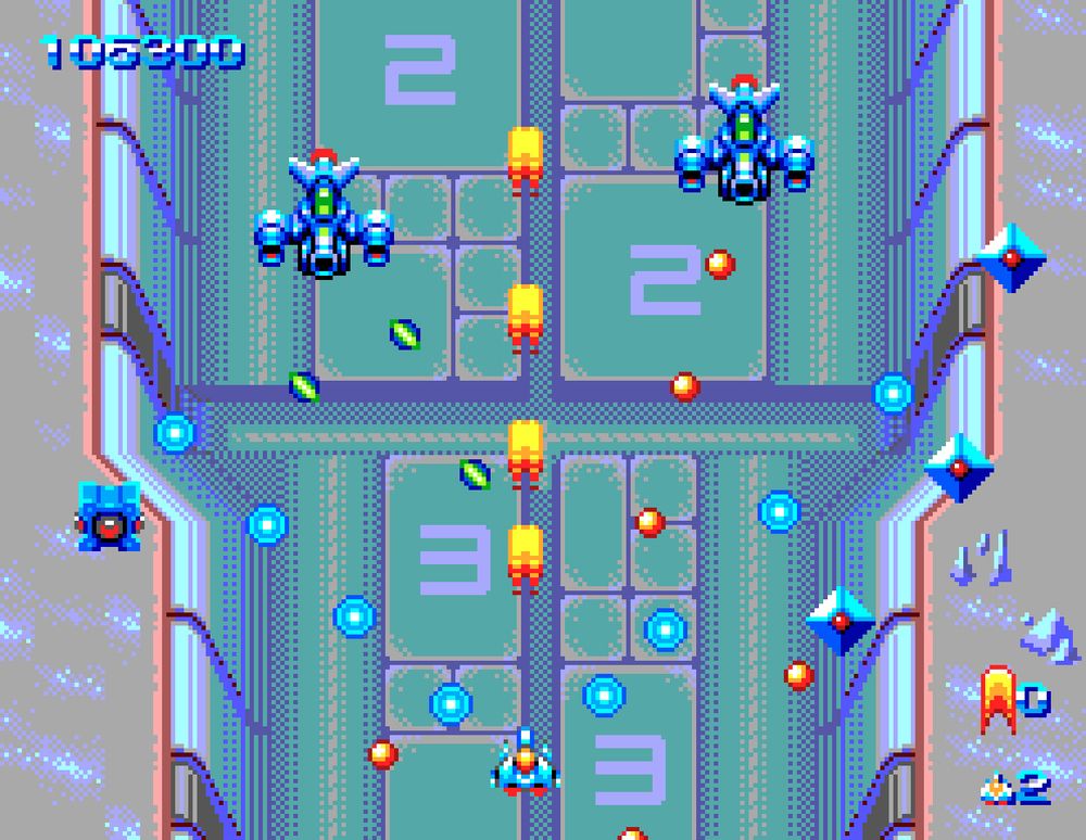 Screenshot of a shoot 'em up game with the player ship at the bottom firing upwards facing multiple enemies from above. The background is an icy landscape with a constructed canyon carved into it.