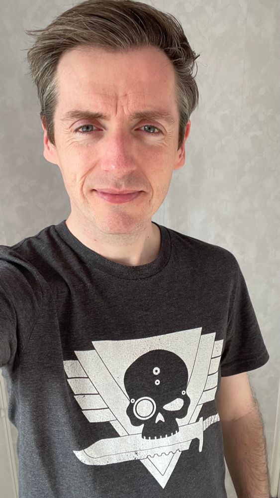 Mike in a dark grey t-shirt with the Kill Team logo