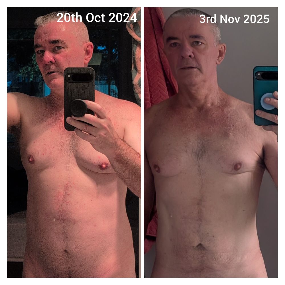 Man with shirt on holding a mobile phone in his hand in front of a mirror