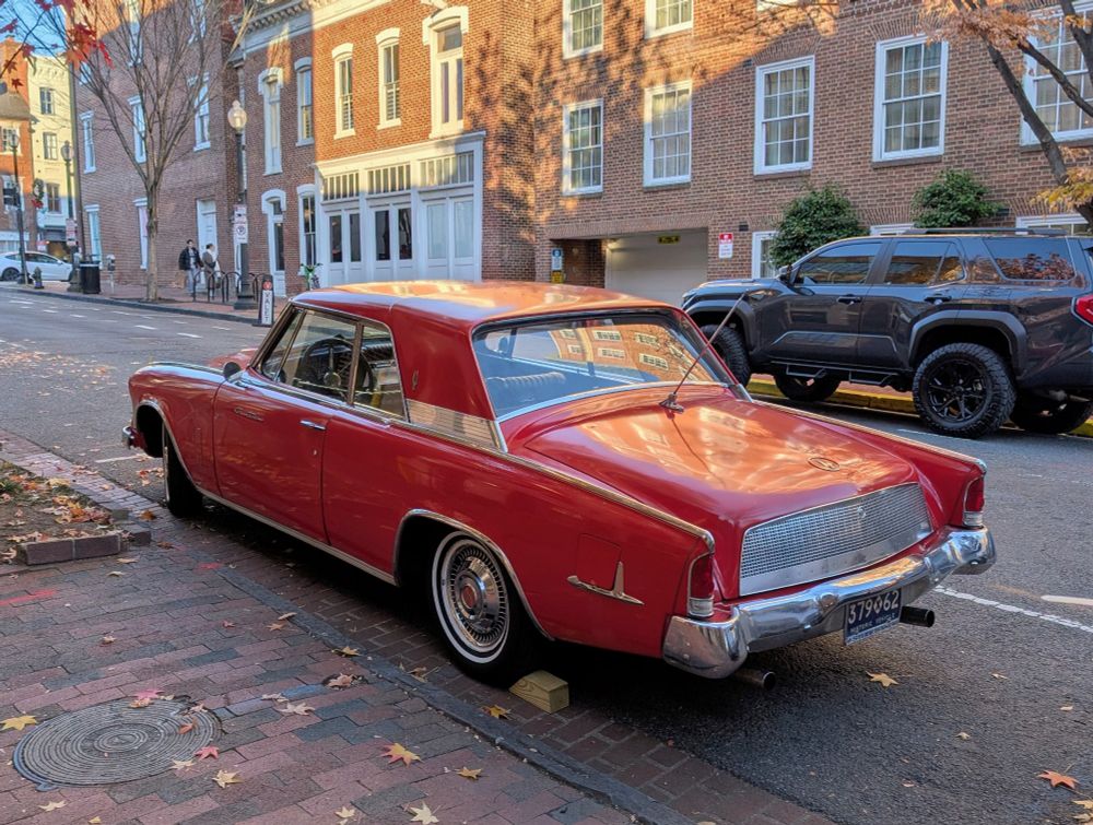 Red vintage car parked on a city street