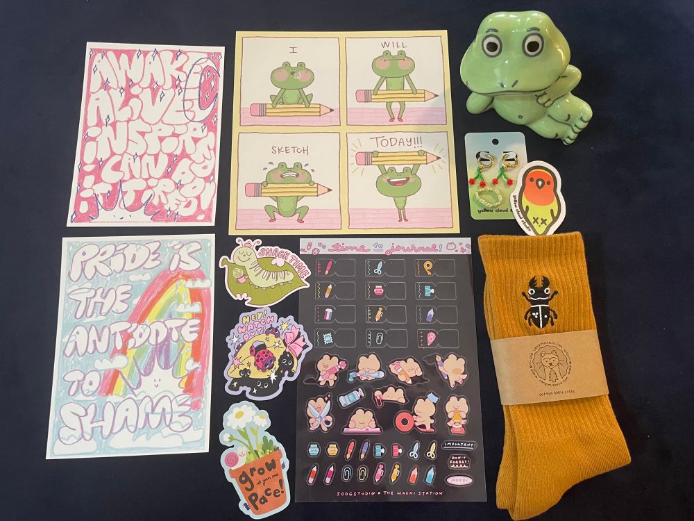 Photo of various prints, stickers, apparel and ceramic art 
