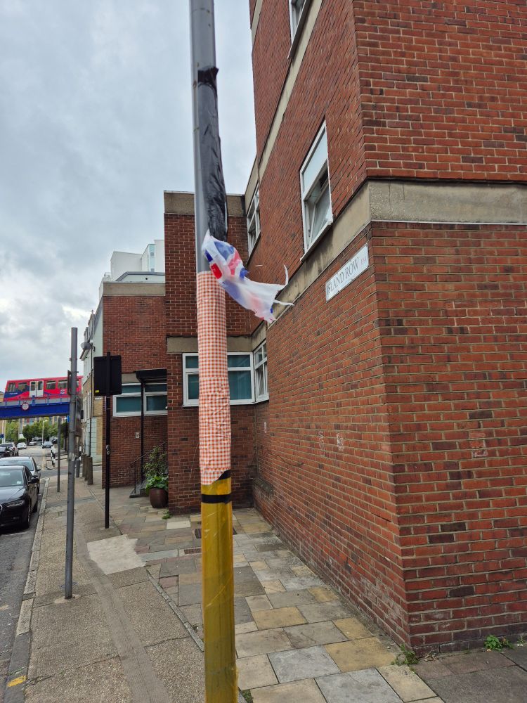 A torn Union Flag adorns a lamp post off Commercial Rd in Limehouse