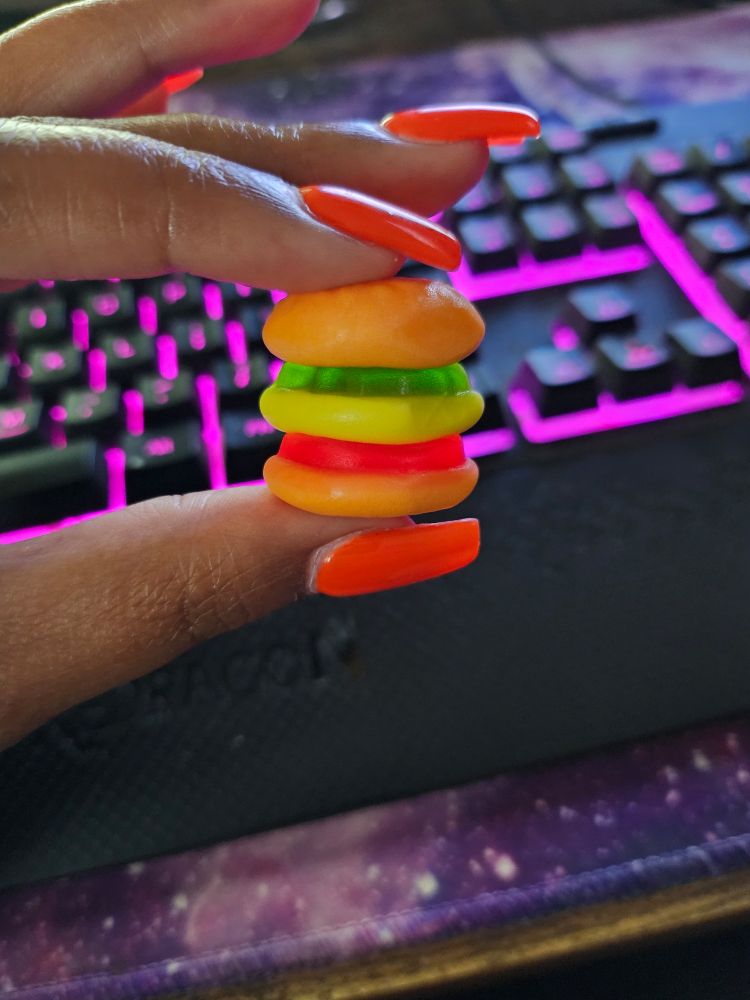 A tiny gummy shaped like a cheeseburger