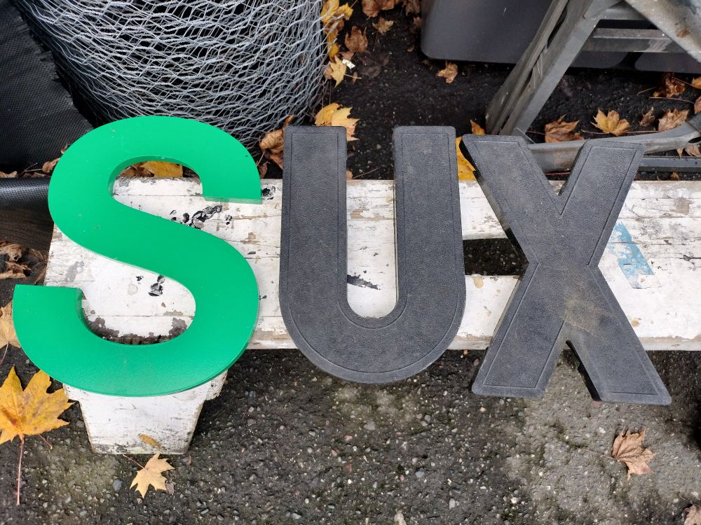 SUX in big novelty letters.