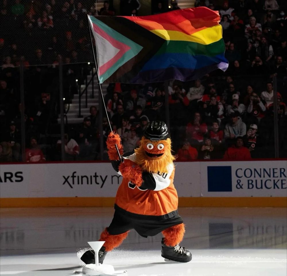 Philly Flyers Hockey mascot Gritty carries the LGBTQ flag on the ice.
