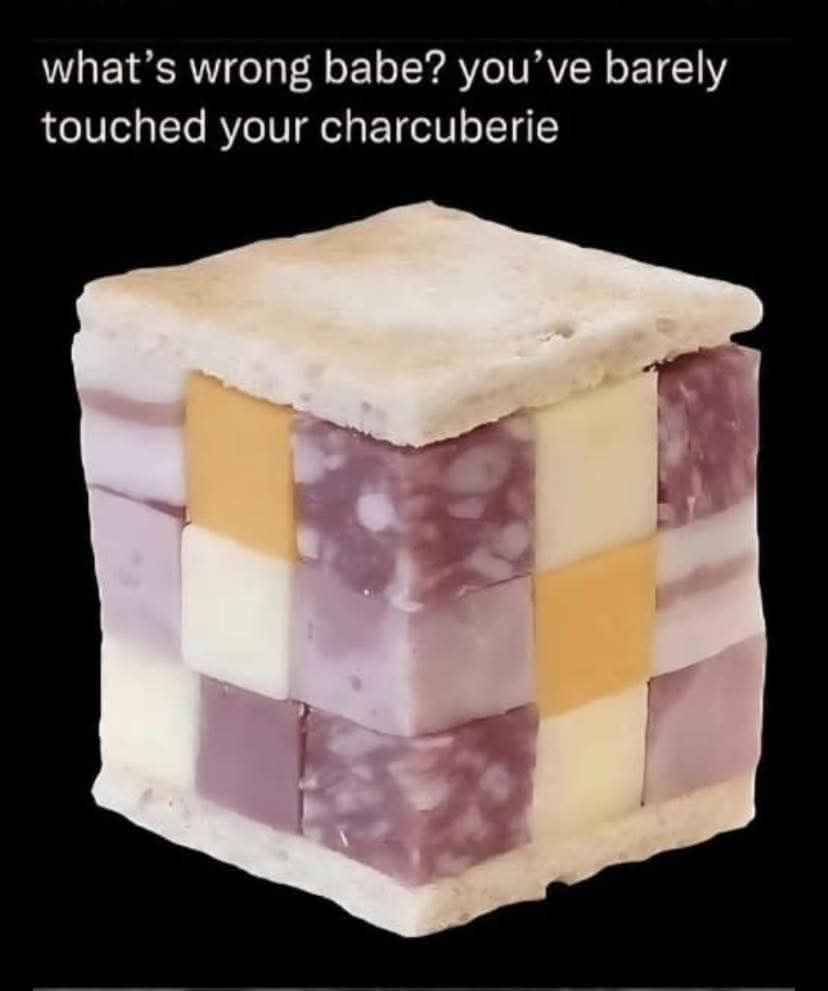A sandwich of different cubed meat and cheese with a description that says "what's wrong babe? You've barely touched your charcuberie"
