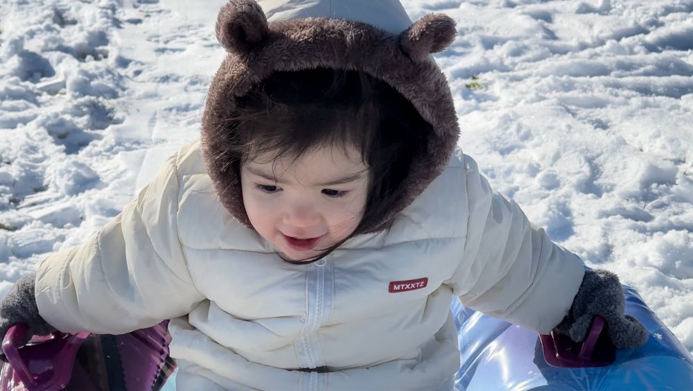 Toddler snowtubing