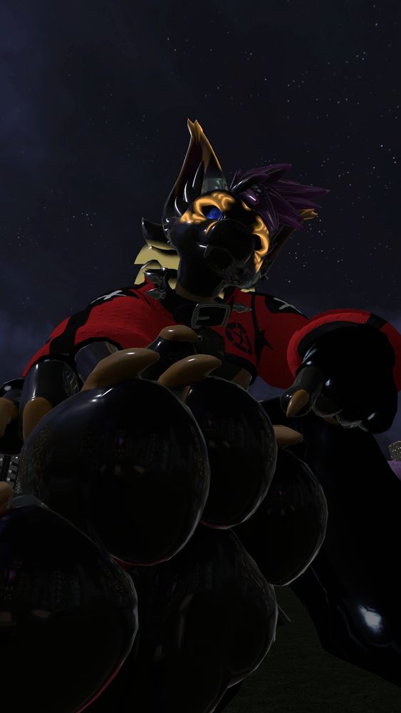 macro rubber jackal pointing at one of their paws, beckoning the viewer