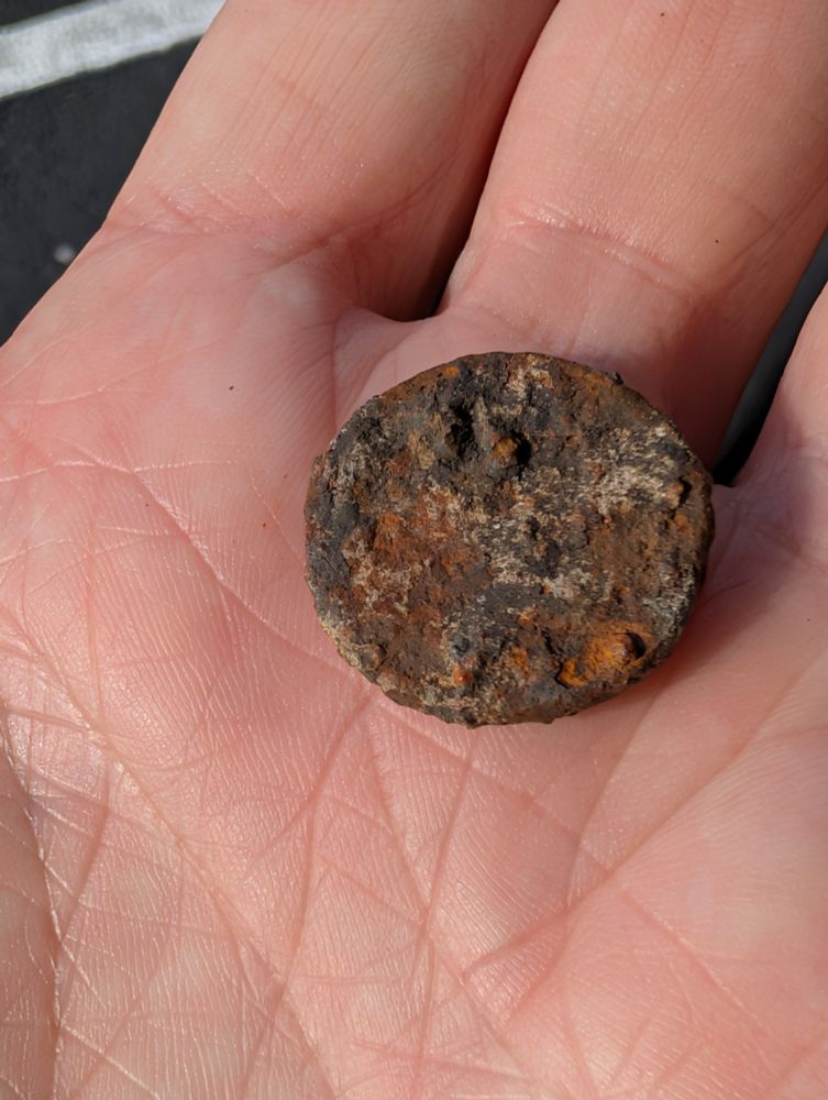 Metal disc about the size of a quarter 