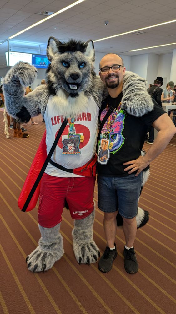Myself taking a photo with Erikku, a werewolf wearing a lifeguard outfit.