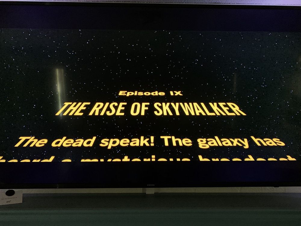 photo of a tv screen with the title card for Rise of Skywalker proclaiming "The dead speak!"