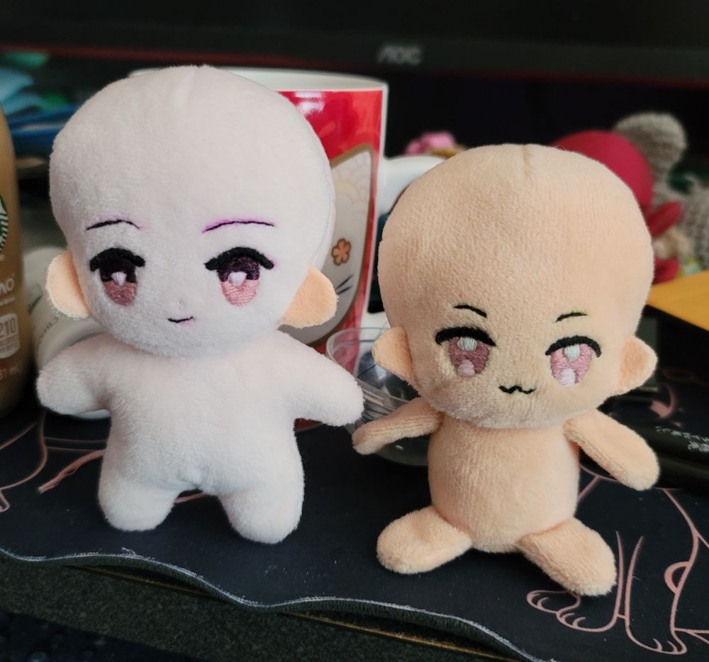 mock-up plush dolls , one standing and one sitting . can't decide which one i like more or both