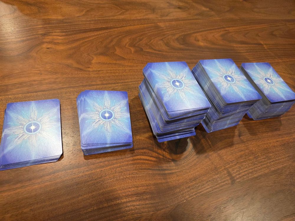 five piles of Hubworld: Aidalon cards, for drafting purposes