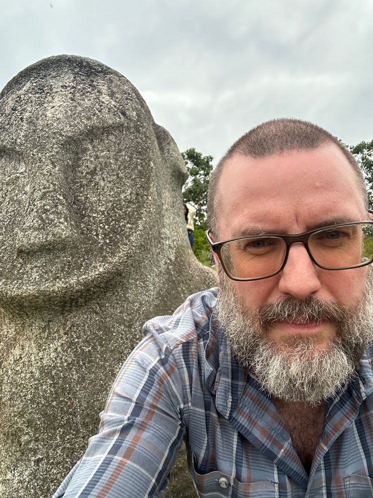 A five thousand year old megalith poses beside author J. Ashley-Smith (who is almost as old).
