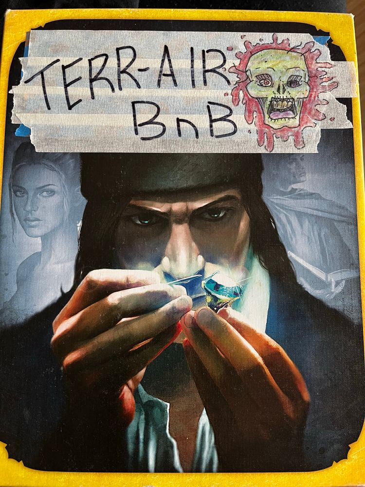 The splendor boardgame box with tape over the title. Written on the tape is the game name, Terr-Air BnB and the drawing of a zombie head in front of a blood splatter