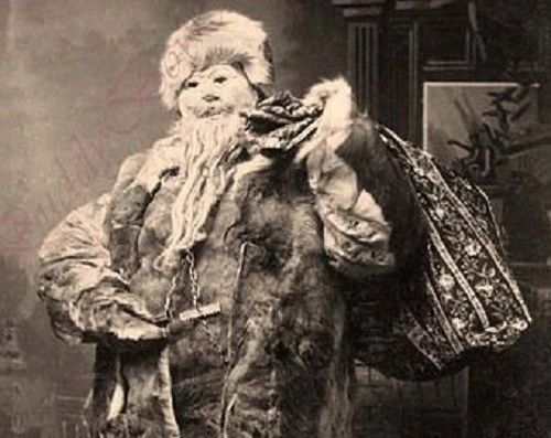 Creepy looking large male figure dressed all in furs with a fur mask covering his face carrying a large carpet bag over his shoulder.