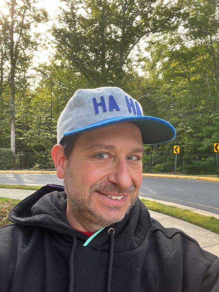 Middle aged gent in a Minnehaha Motors vintage baseball hat