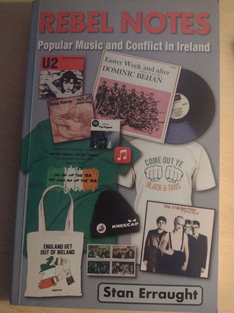 Cover of Rebel Notes book, featuring record sleeves by Dominic Behan, U2, the Cranberries and merchandise from Kneecap and the Wolfe Tones.