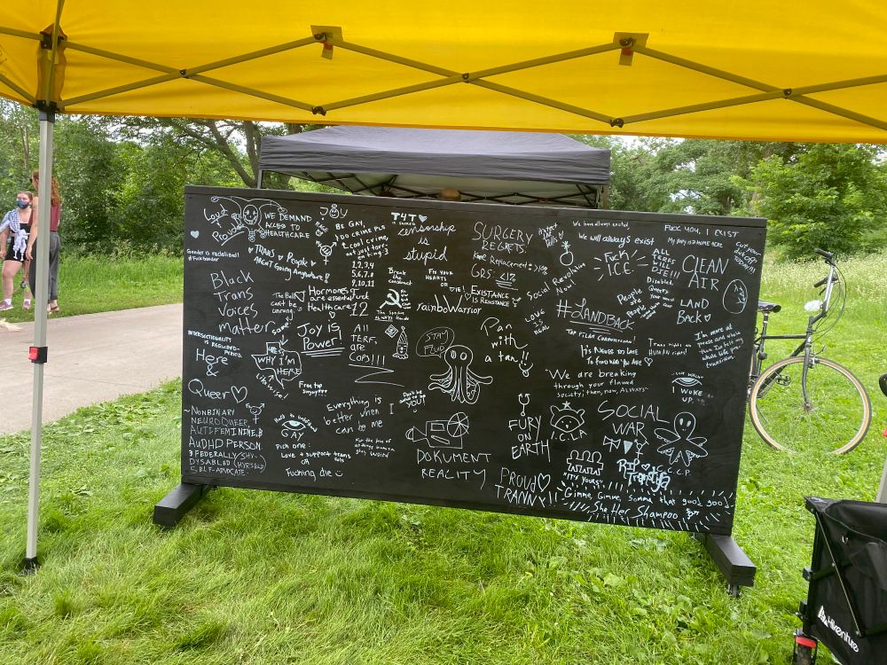 Image of the menace art wall at the booth as People's Pride.