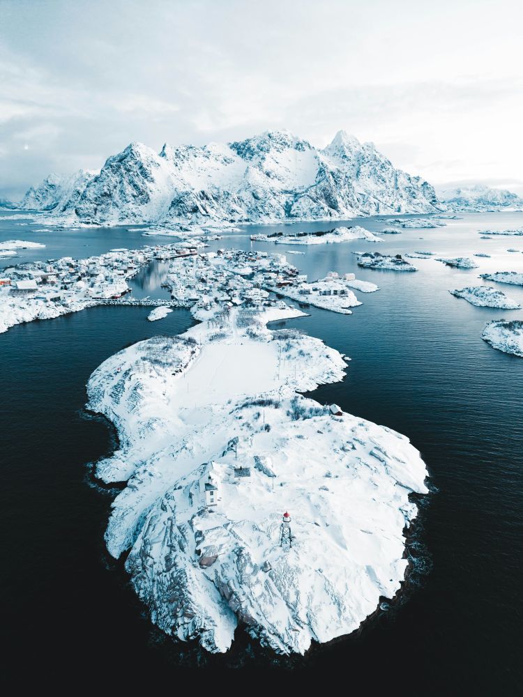 Bright white icebergs in dark blue water