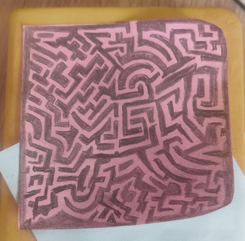 Pencil drawing of a maze on a pink sticky-note