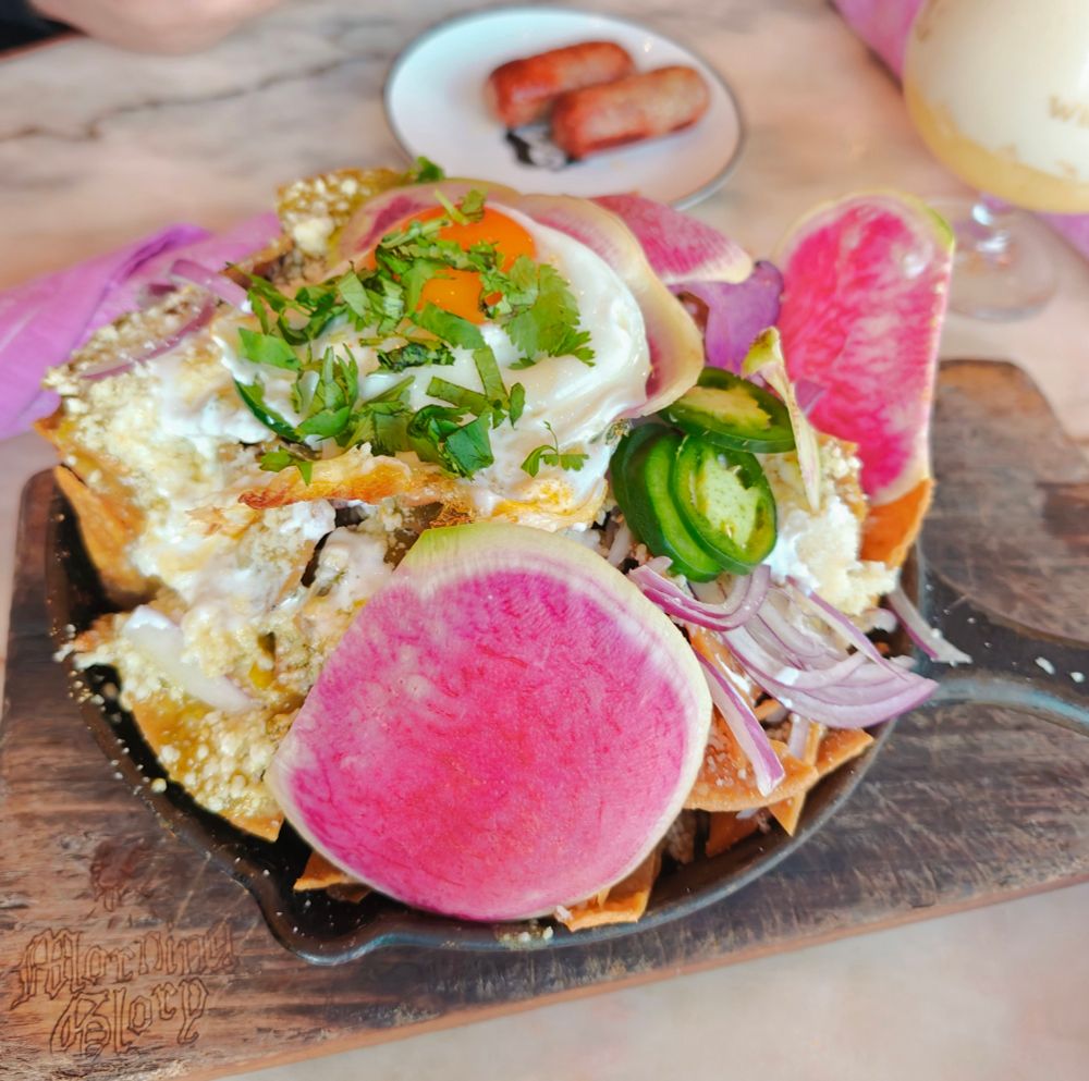 a skillet of chilaquiles. the waterlemon radishes really pop in color